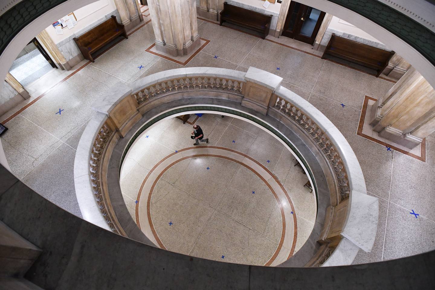 Blue tape marks the floors of the Kankakee County Courthouse every six feet to enforce social distancing guidelines ahead of reopening May 27, 2020. The normally bustling halls of downtown government were barren except for the dozens of X’s throughout the building.
