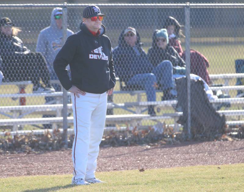 Hall head baseball coach Tom Keegan stands on the third base line while coaching his team against Putnam County on Monday, March 17, 2025 at Putnam County High School.