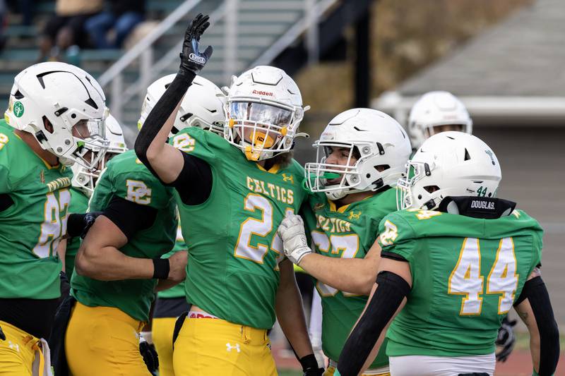 Providence's Broden Mackert celebrates with teammates after scoring a touchdown during a 5A varsity football playoff game against Washington at Providence on Nov. 15, 2025.