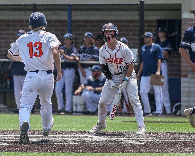 Oswego's Kenny White (13) is greeted at the plate by Drake Dunnett (12) during Class 4A Romeoville Sectional final game between Oswego East at Oswego.  June 3, 2023.
