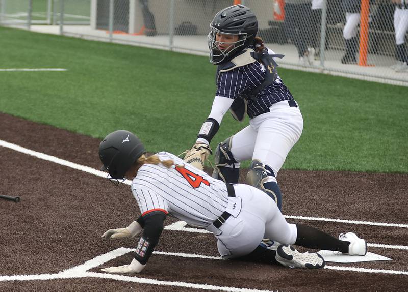 McHenry's Hailey Townsend slides into home as Cary-Grove's Avery Mattran tries to apply as tag during a Fox Valley Conference softball game on Thursday, April 30, 2026, at McHenry High School.