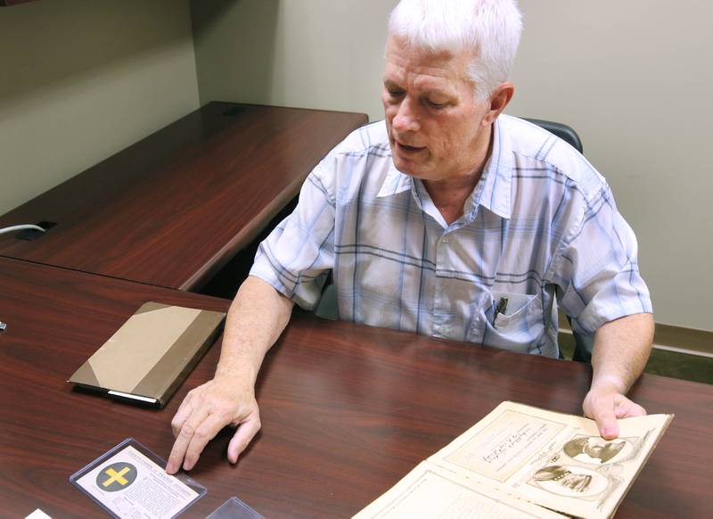 DeKalb resident John Wright talks Monday, Oct. 7, 2024, about some of the items he found in WWI U.S. Army soldier Albert Leonhard’s service record book that he purchased at a local estate sale.