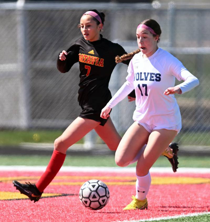 Oswego East’s Riley Gumm, right, gets ready to make a pass that led to a goal for her team as she stays ahead of Batavia’s Brianna Solis during a girls soccer match in March 2024 in Batavia.