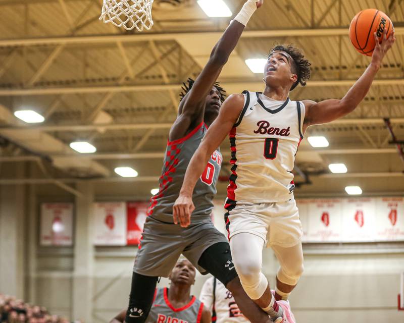 Benet's Blake Fagbemi (0) puts up an acrobatic shot during their When Sides Collide Shootout basketball tournament matchup between Rich Township at Benet Academy. Jan 25, 2025 in Lisle.