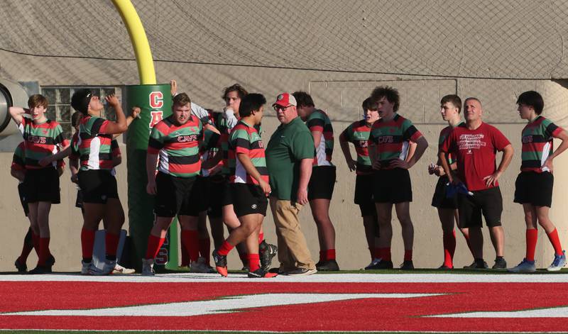 Members of the L-P rugby team gather in the end zone while playing La Salette Academy during a rugby game on Wednesday, April 12, 2023 at Howard Fellows Stadium at L-P High School.
