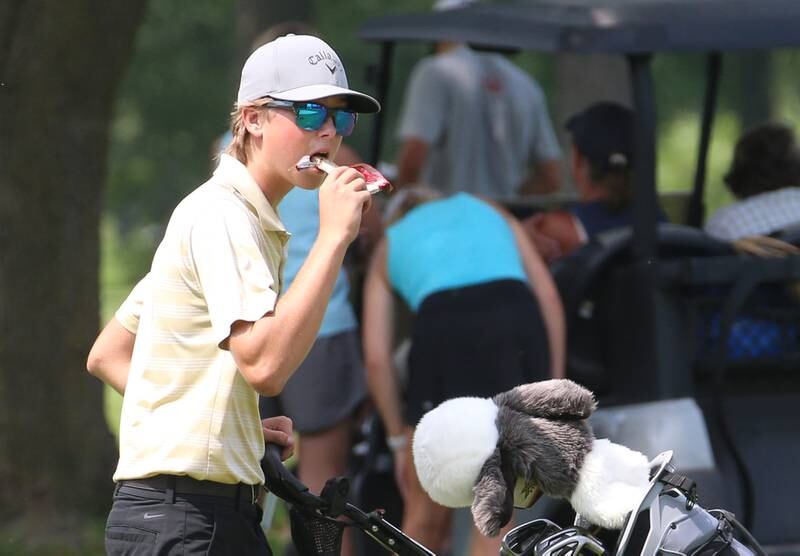 L-P's Michael Milota munches on a granola bar while playing in the Streator Bulldog Invitational boys golf meet on Monday, Aug. 21, 2023 at Eastwood Golf Course in Streator.