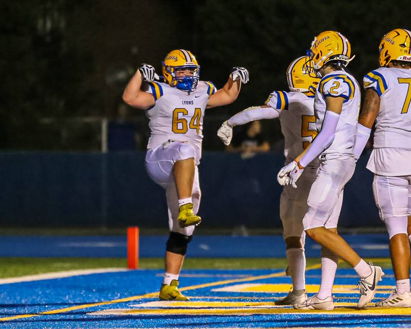 Lyon's Cooper Komsthoeft (64) celebrates a touchdown run by Danny Caroll (5) during football game between Hinsdale Central at Lyons.  Sept 8, 2023.
