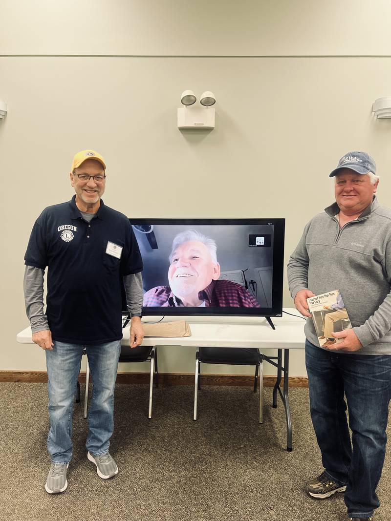 Pictured at left is Lion Mark Bennett, at center is Bill Massey and at right is Doug Williams, who won a copy of Bill's book. 100% of the proceeds from Bill’s book sales go back to helping other blind people in need.