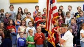 Polo grade school students sing and smile their thanks to veterans