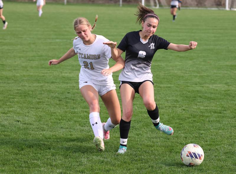 Kaneland's Taylor Mills holds off Sycamore's Kelsie Ryder during their game Monday, April 13, 2026, at Kaneland High School.