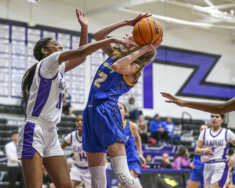 Johnsburg's Skye Toussaint (32) is fouled on a shot attempt during their basketball game between Johnsburg at Plano, Monday Dec 16, 2024 in Plano.