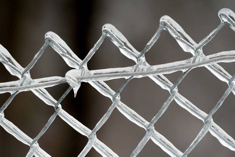 Ice encased fencing at the Hopkins Park sledding hill in DeKalb on Wednesday, Dec. 30, 2020.