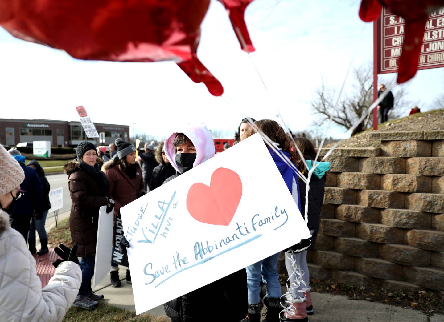 Sabina Bosell of Downers Grove holds a sign in honor Maria and Sebastian Abbinanti outside AMITA Health St. Joseph Hospital in Elgin on Wednesday, Dec. 22, 2021 after a Kane County judge denied a request to allow the drug Ivermectin be administered to fight their COVID-19 infection. Maria Abbinanti passed away in the early morning hours of Wednesday, Dec. 22, 2021 and her husband, Sebastian, is still hospitalized.