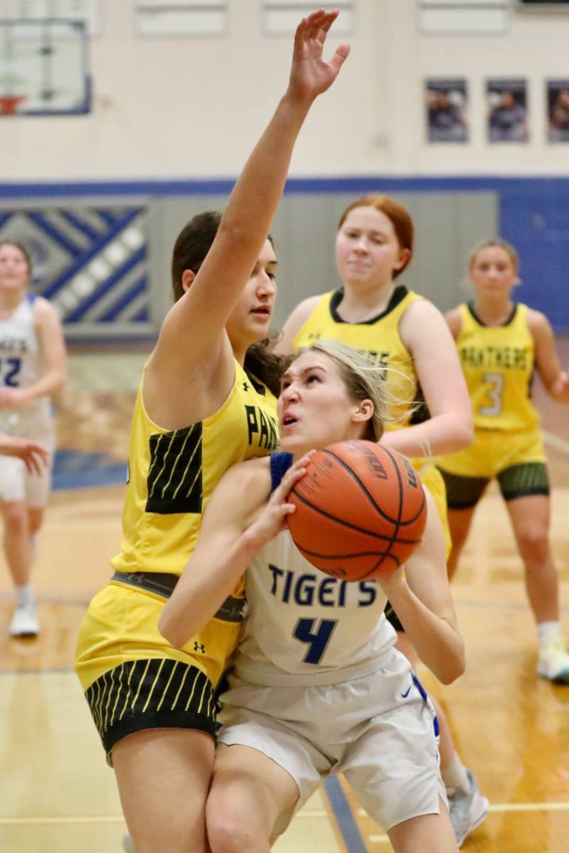 Princeton's Erin May eyes the bucket against Putnam County's Maggie Richetta in tournament play at Princeton Monday. The Tigresses won 62-36.