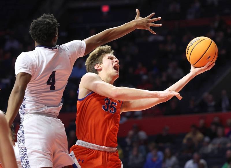 Eastland's Parker Krogman ducks under Chicago Hope Academy's Andre Mabry to get up a shot during their IHSA Class 1A state championship game Saturday, March 15, 2025, in the State Farm Center at the University of Illinois in Champaign.