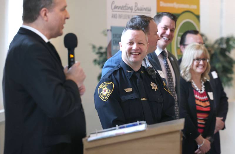 Members of the contingent from the DeKalb County Courthouse laugh as Bradley Waller, 23rd Judicial Circuit Court Chief Judge, speaks on behalf of the courthouse which won the Sycamore Chamber of Commerce Chamber Champion Award during the 106th Annual Chamber Meeting Thursday, March 2, 2023, in Memorial Hall at St. Mary's Catholic Church in Sycamore.
