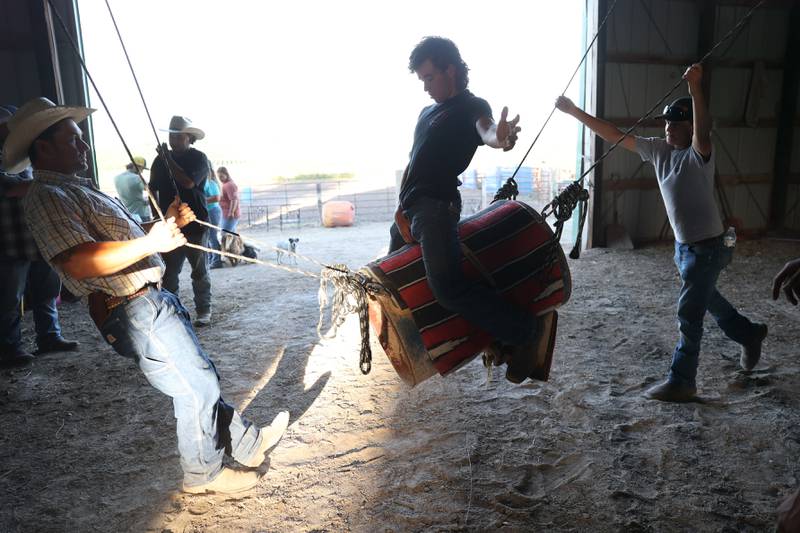 Trainer Matt Wright, left, works on bull riding techniques with Dominic Dubberstine-Ellerbrock at his ranch. Dominic will be competing in the 2022 National High School Finals Rodeo Bull Riding event on July 17th through the 23rd in Wyoming. Thursday, June 30, 2022 in Grand Ridge.