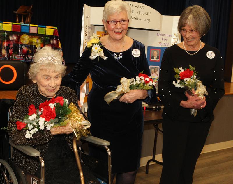 Vivian Anderson holds her flowers after being crowned, Prom Queen, while Jackie Wirtz and Jerry Hoes stand next to her during the Senior Prom to celebrate the 50th Anniversary of Leisure Village in Fox Lake.