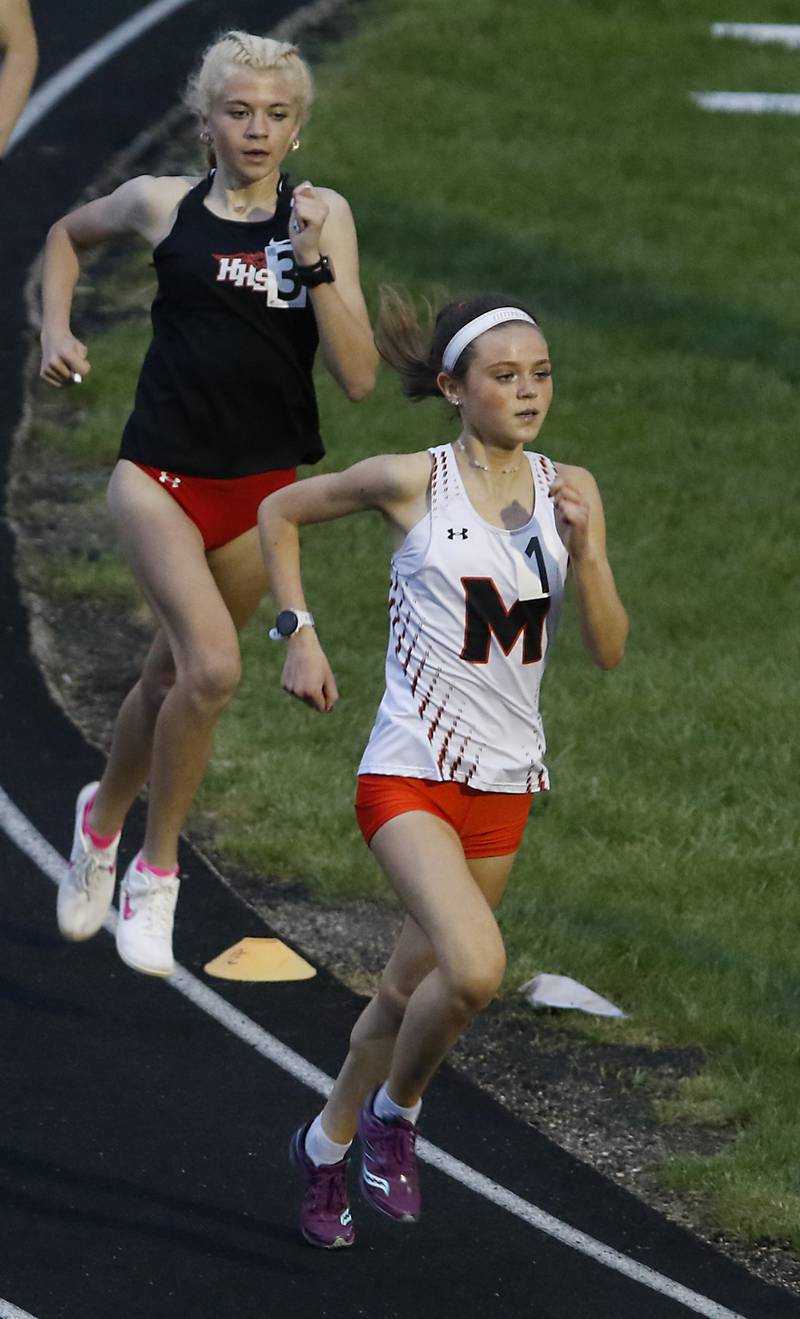 Huntley’s Cori Kilvinger chases down McHenry’s Skyler Balzer on the last lap of the 1600 meter run on Thursday, May 2, 2024, during the Fox Valley Conference Girls Track and Field Meet at Jacobs High School in Algonquin.