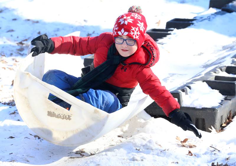 Reid Chlum of Princeton, uses a barrel to slide down a toboggan run during the Lowaneu Cub Scout Yukon on Saturday, Jan. 31, 2026 at Hall Township Echo Bluff Park in Spring Valley.