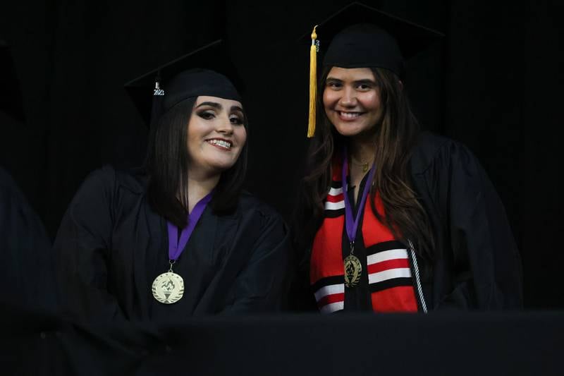 Graduates poses while waiting near the stage for their certificate at the Joliet Junior College Commencement Ceremony on Friday, May 19, 2023, in Joliet.