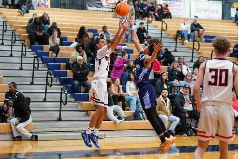 Oswego’s Ethan Vahl (3) shoots a three pointer against Plainfield South's Corey Nobles (2) during a basketball game at Oswego High School on Friday, January 17, 2025.