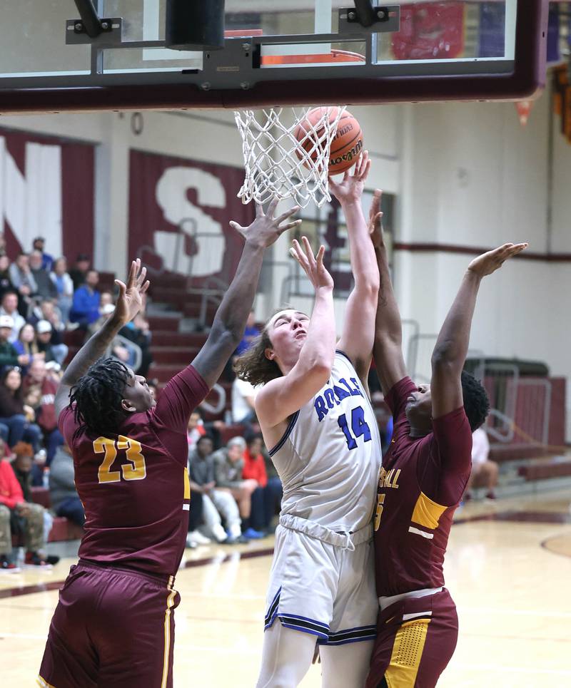 Hinckley-Big Rock's Martin Ledbetter gets a shot off between two Chicago Marshall defenders Wednesday, March 1, 2023, during their Class 1A sectional semifinal matchup at Elgin High School.