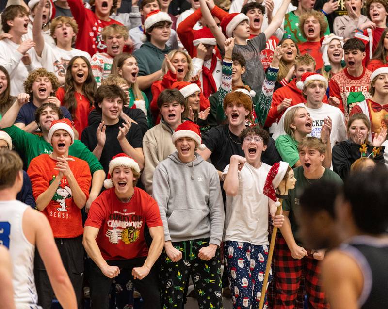 The Burlington Central student section cheers after their team scores during a home game against Hampshire High School on Friday, Dec. 22, 2023.