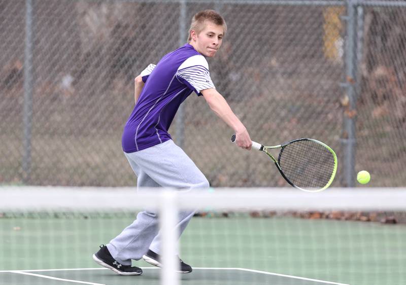 Dixon’s Derek Miller hits a backhand during his number one doubles match along with partner Owen Winter against Sycamore Thursday, March 30, 2023, at Sycamore High School.