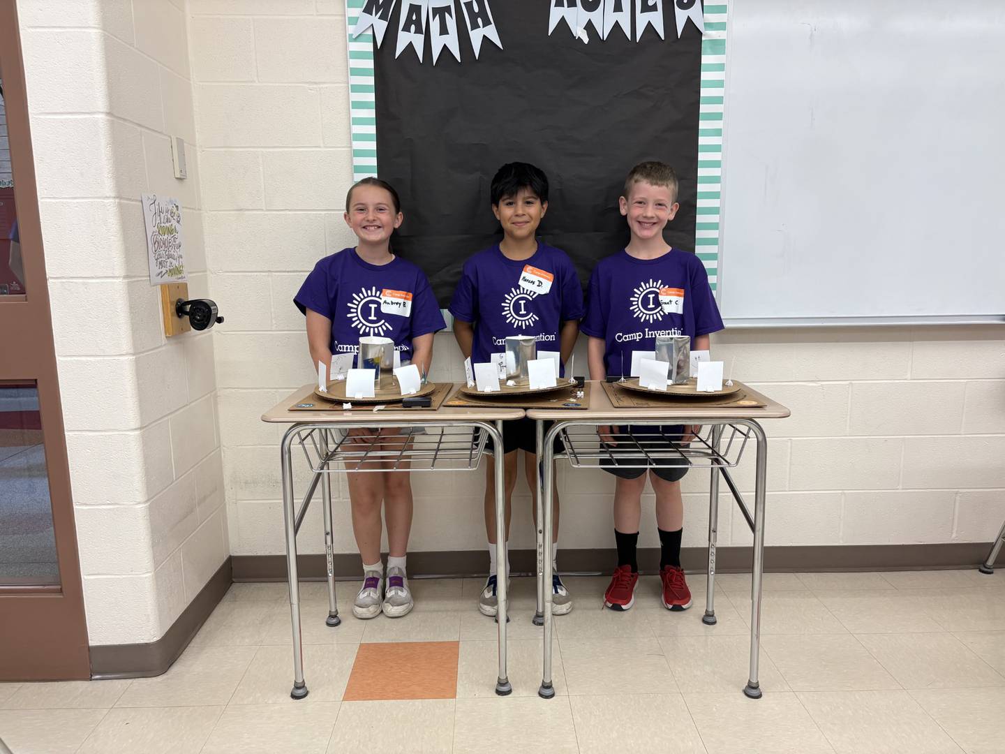 Camp Invention participants Aubrey, Marcos and Grant pose with their finished animation projects on the final day of the program at Central Intermediate School in Ottawa, June 13, 2025.