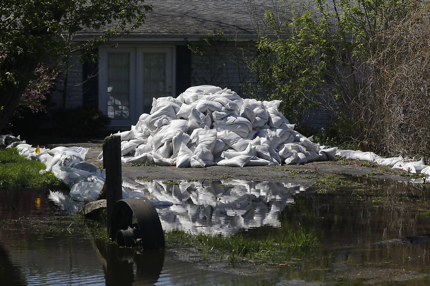 Sandbags protect a home in Holiday Hills  as flooding continues on the Fox River on Wednesday, April 22, 2026.