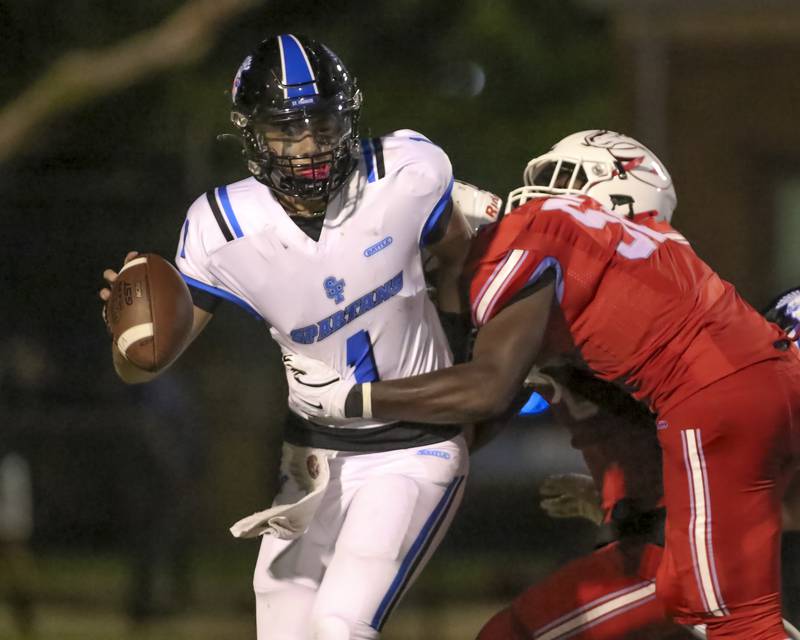 St. Francis's Brock Phillip (1) is sacked during football game between St. Francis at Kenwood Academy on Thursday, Aug 28, 2025  in Chicago.