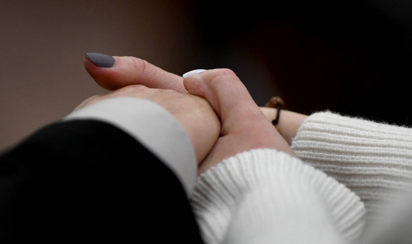 Brett Herold and his girlfriend hold hands while waiting for his sentence to be handed down Friday, Feb. 18, 2022, at the McHenry County Courthouse in Woodstock. Herold pleaded guilty in October to driving under the influence and failing to report a fatal crash.