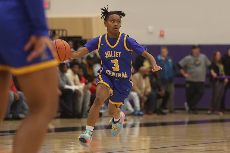 Joliet Central’s Sakia Pruitte looks for a play against Joliet West at Joliet Junior College.