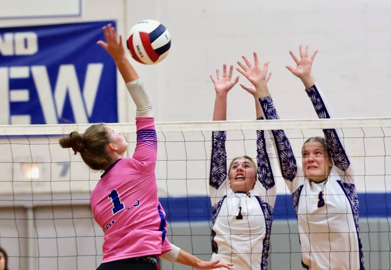 Newman sophomore Lauren McClain hits over Sherrard's jaeci Leffel and Grace Bohnert in Tuesday's regional semifinal match at Princeton.