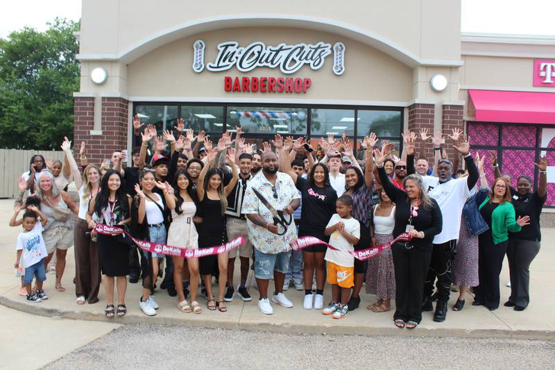 The DeKalb Chamber of Commerce celebrating In and Out Cuts Barbershop's expansion