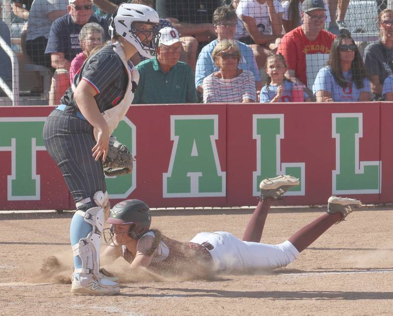 Dunlap's Addie Reed scores as Ottawa catcher Bobbi Snook waits for the late throw to the plate during the Class 3A semifinal game on Tuesday, May 26, 2026 at the L-P Athletic Complex in La Salle.