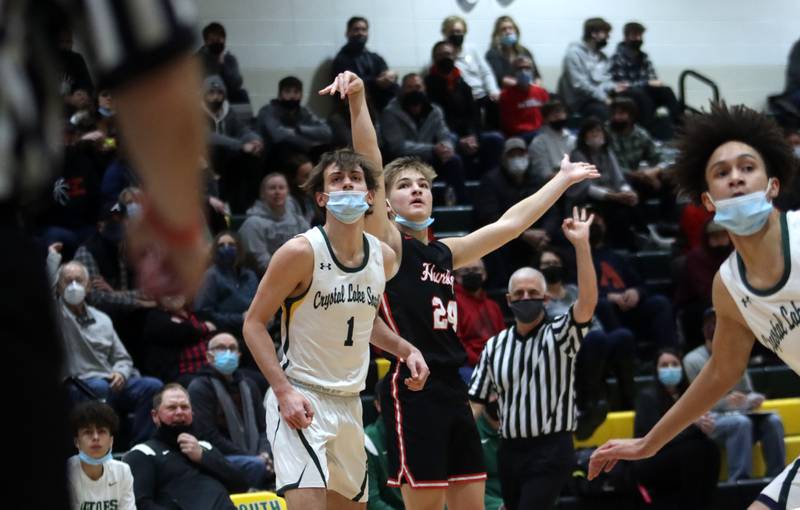 Huntley’s Aiden Wieczorek, center, puts the finishing touches on a three-point basket as Crystal Lake South’s Zach Peltz, left, land Isaiah Kirkeeng, right, look on in boys varsity basketball at Crystal Lake Friday night.