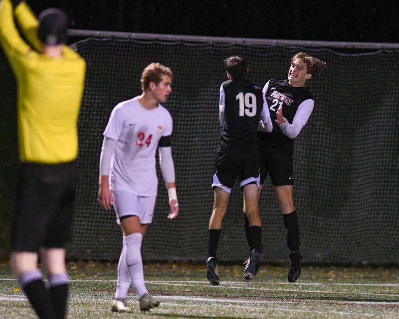 Prairie Ridge's back/ Midfielder Nicolas Flaugher (21) celebrates with teammate Trenton Pavoris (19) after Nicolas scores a goal during the class 2A super sectional soccer match on Tuesday Nov. 5, 2024, held at Wheaton Academy in West Chicago.
