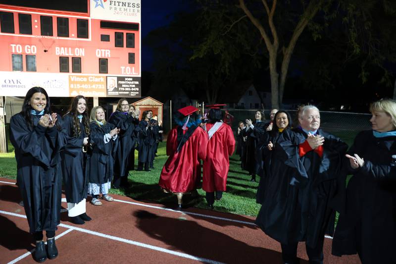 Teachers and staff applaud as graduates leave the stadium following the Bradley-Bourbonnais Community High School commencement ceremony on Thursday, May 21, 2026.