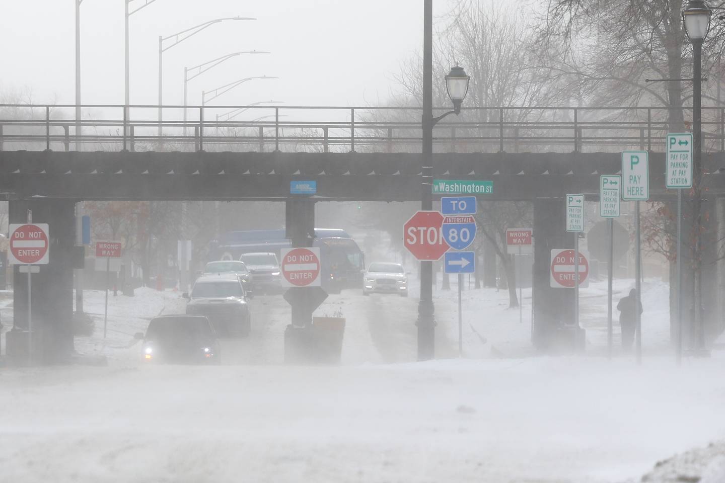 High winds blow snow across Chicago Street in Downtown Joliet.