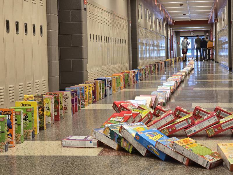 About 750 cereal boxes tumble in a line Tuesday, March 18, 2025, in the hallways of Streator High School.