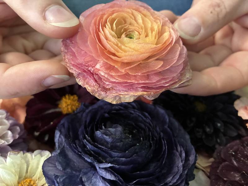 Dried flowers from a wedding arrangement at Bupp Woodworks & Designs on Nov. 28, 2025. The McHenry-based business encase the flowers in resin to preserve them.