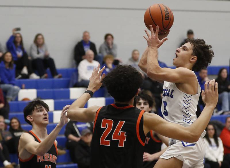 Burlington Central's Lucas Kerr drives to the basket between McHenry's Hayden Stone (left)  and Adam Anwar during a Fox Valley Conference boys basketball game Tuesday, Jan. 30, 2024, at Burlington Central High School.