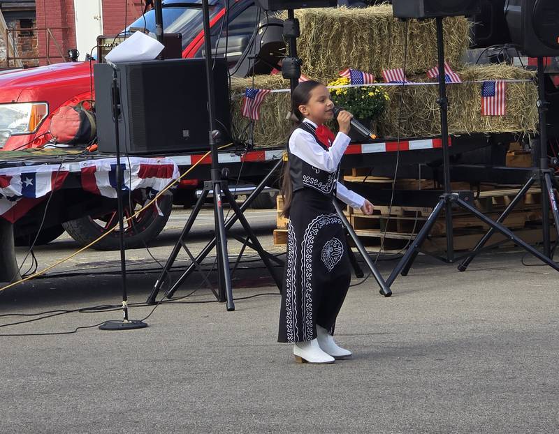 A young singer performs Saturday, Sept. 21, 2024, at Amigo Fest in Mendota.