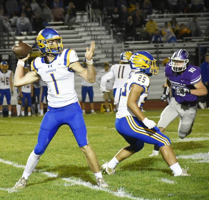 Johnsburg quarterback AJ Bravieri throws a pass as Rochelle defender Ethan Goodwin lurks during Friday evening’s Interstate 8/Kishwaukee River Blue Division matchup on September 9, 2023