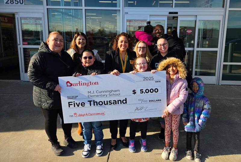 M.J. Cunningham Elementary School Principal Marysol Sandoval, Assistant Principal Kelley Ratajczak, staff, students, and parents from the Cunningham PTO are presented with a check at the Burlington Grand Opening in Joliet. 
Feb. 25, 2025