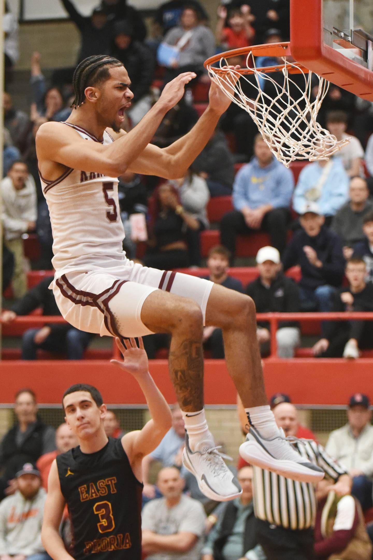 Kankakee's EJ Hazelett releases from the rim after throwing down a dunk during the IHSA Class 3A Ottawa Sectional semifinals against East Peoria Wednesday, March 4, 2026.