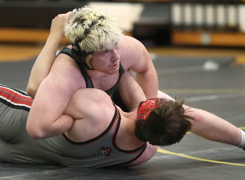 Sycamore’s Gable Carrick scores points against Ottawa’s Ryan Wilson during their 190 pound match Thursday, Dec. 14, 2023, at Sycamore High School.