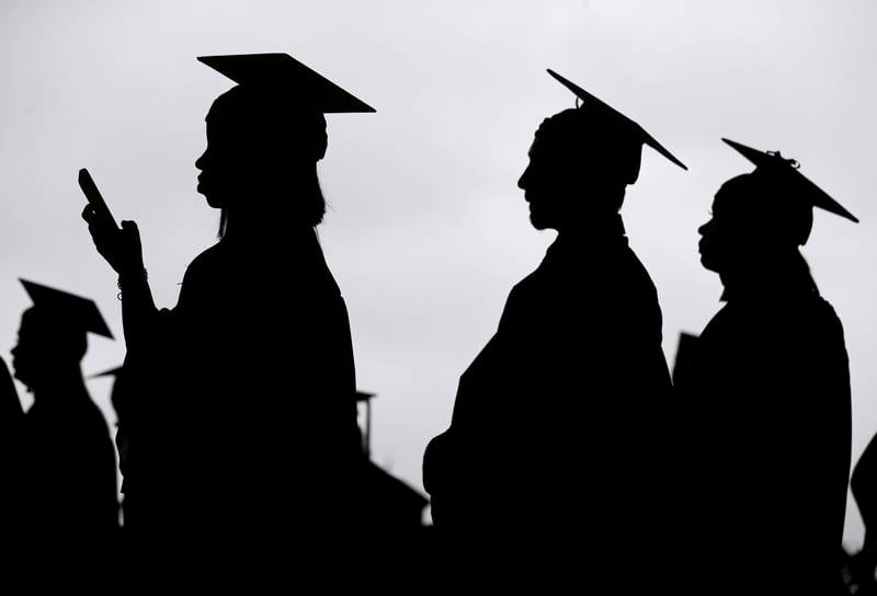 FILE - New graduates line up before the start of a community college commencement in East Rutherford, N.J., on May 17, 2018. President Joe Biden is expected to announce Wednesday Aug. 24, 2022 that many Americans can have up to $10,000 in federal student loan debt forgiven. (AP Photo/Seth Wenig, File)